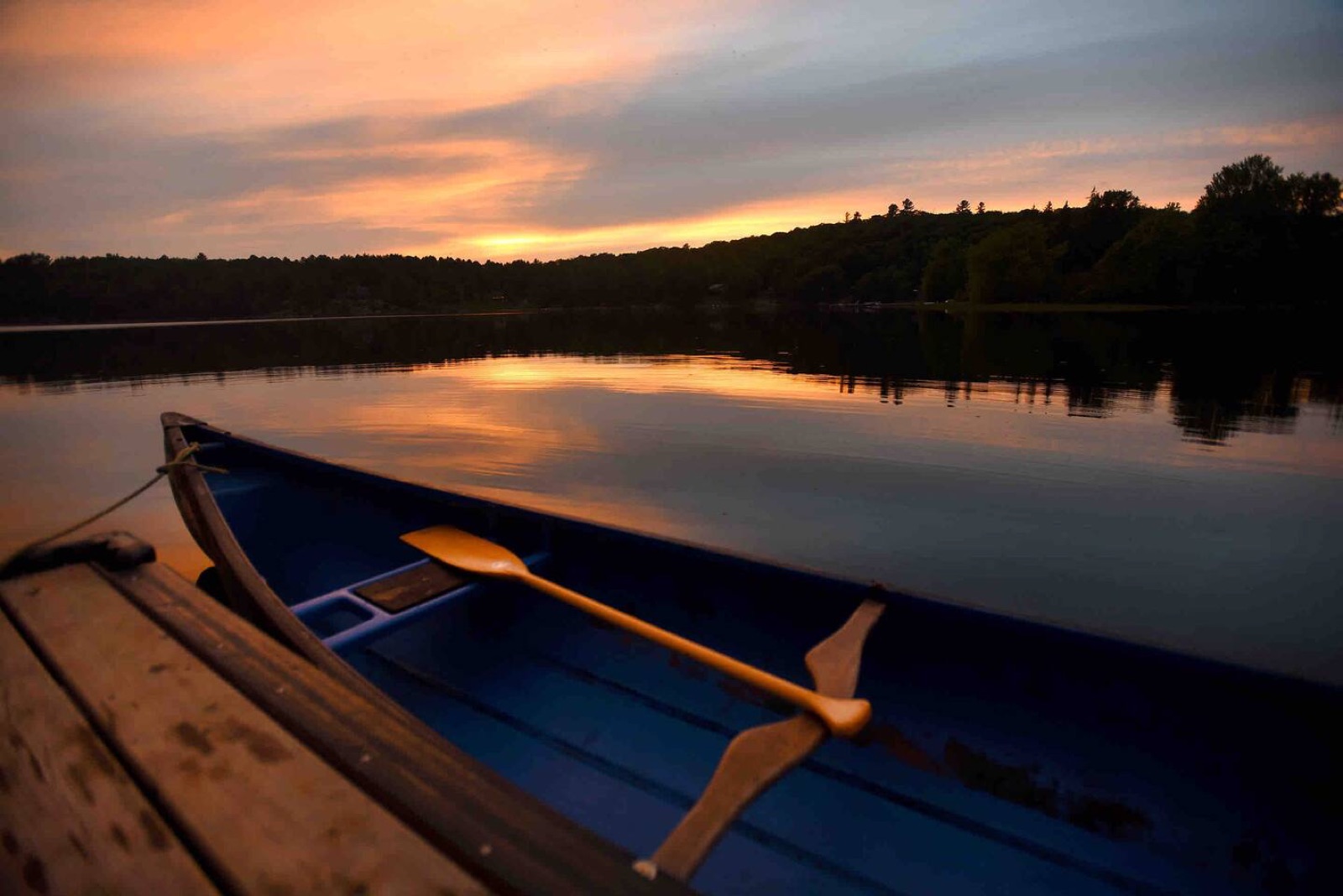 A canoe on the dock at sunset